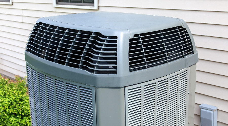 Air conditioning unit outside a home, relevant to central AC and ductless mini split system comparison.